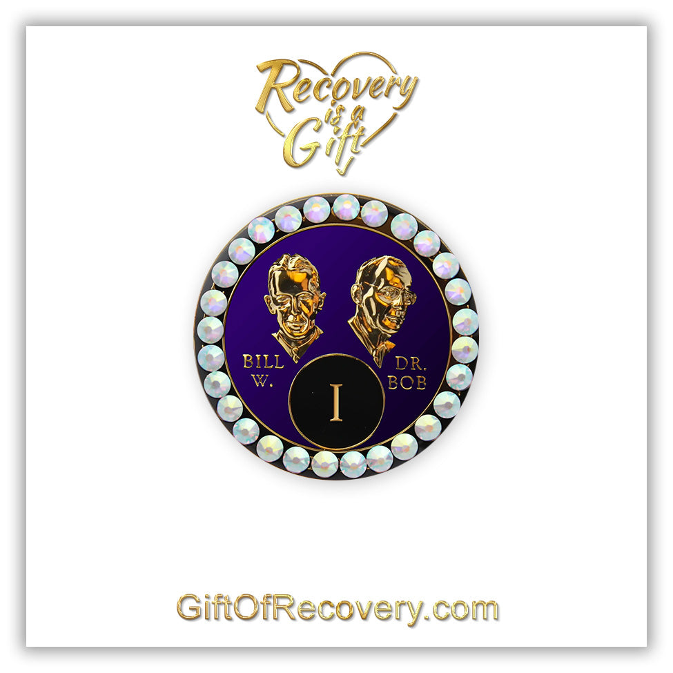1 year AA Bill & Bob Amethyst purple recovery medallion with 28 genuine Aurora Borealis crystals around the rim, this medallion is to honor our founders and our time, stylized busts of Bill W. and Dr. Bob, with their names, in embossed 14k gold-plated brass, the medallion is sealed with resin for a glossy finish, seen on a white 3x3 card with recovery is a gift going through an open heart at the top and giftofrecovery.com on the bottom, both in the color gold.