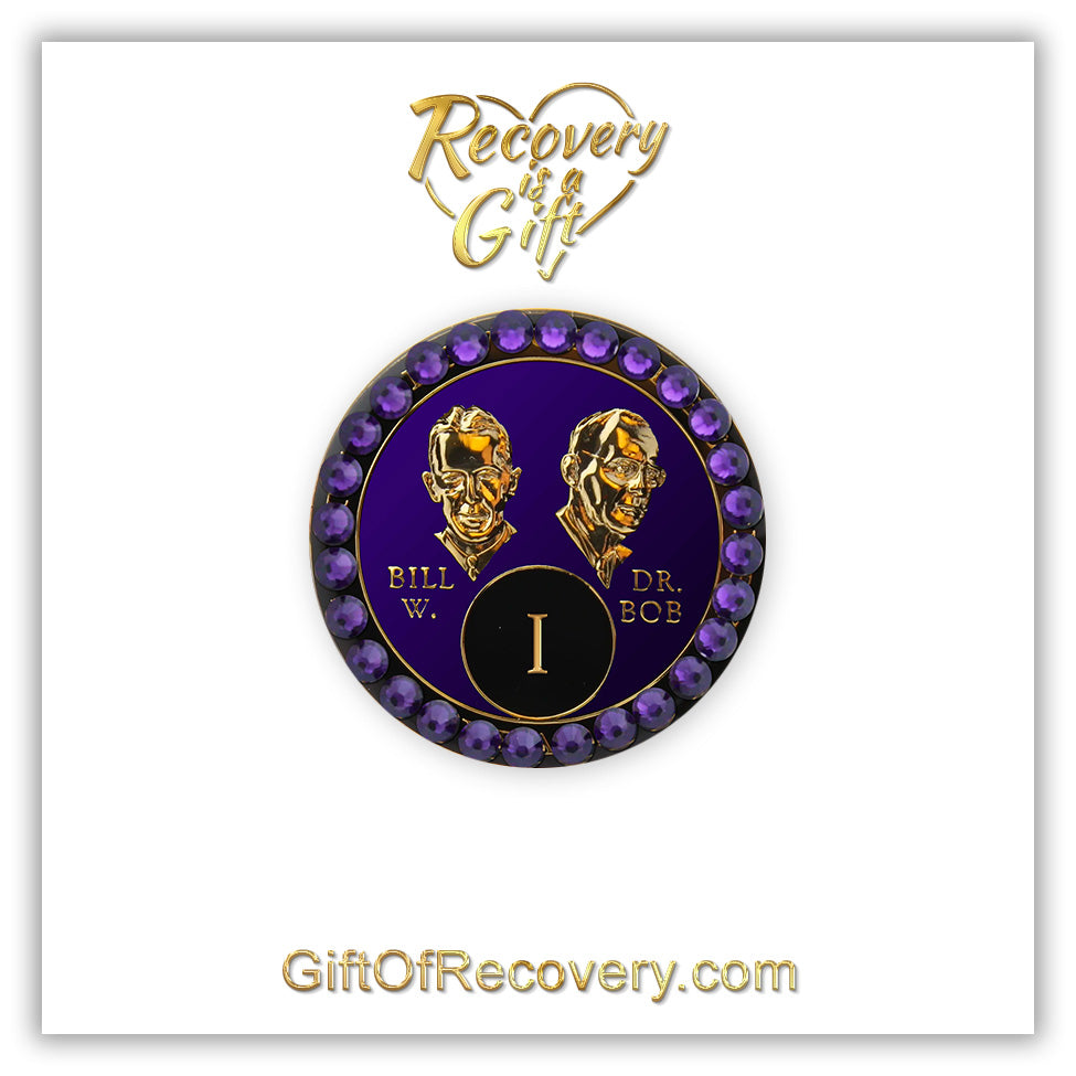 1 year AA Bill & Bob Amethyst purple recovery medallion with 28 genuine purple velvet crystals around the rim, this medallion is to honor our founders and our time, stylized busts of Bill W. and Dr. Bob, with their names, in embossed 14k gold-plated brass, the medallion is sealed with resin for a glossy finish, seen on a white 3x3 card with recovery is a gift going through an open heart at the top and giftofrecovery.com on the bottom, both in the color gold.