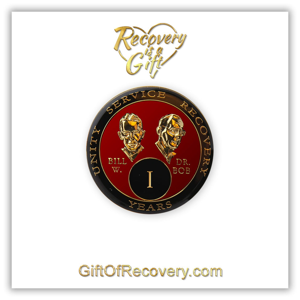 1 year AA Bill & Bob Ruby red recovery medallion, black around the rim with Unity, Service and recovery embossed 14k gold-plated brass, this medallion is to honor our founders and our time, stylized busts of Bill W. and Dr. Bob, with their names, are embossed 14k gold-plated brass, the medallion is sealed with resin for a glossy finish, seen on a white 3x3 card with recovery is a gift going through an open heart at the top and giftofrecovery.com on the bottom, both in the color gold.