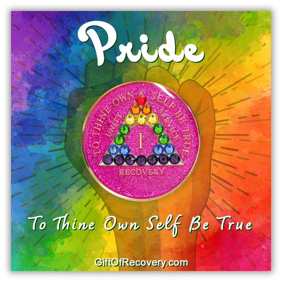 1 year AA medallion pink glitter princess with 21 genuine crystals in the colors of the rainbow to represent the LBGTQIA+ community in the shape of the triangle, the AA moto is embossed with 14k gold-plated brass and sealed with resin, featured on a tie-dye 3x3 card with a silhouette of a fist, pride at the top and to thine own self be true on the bottom, both in bold white.