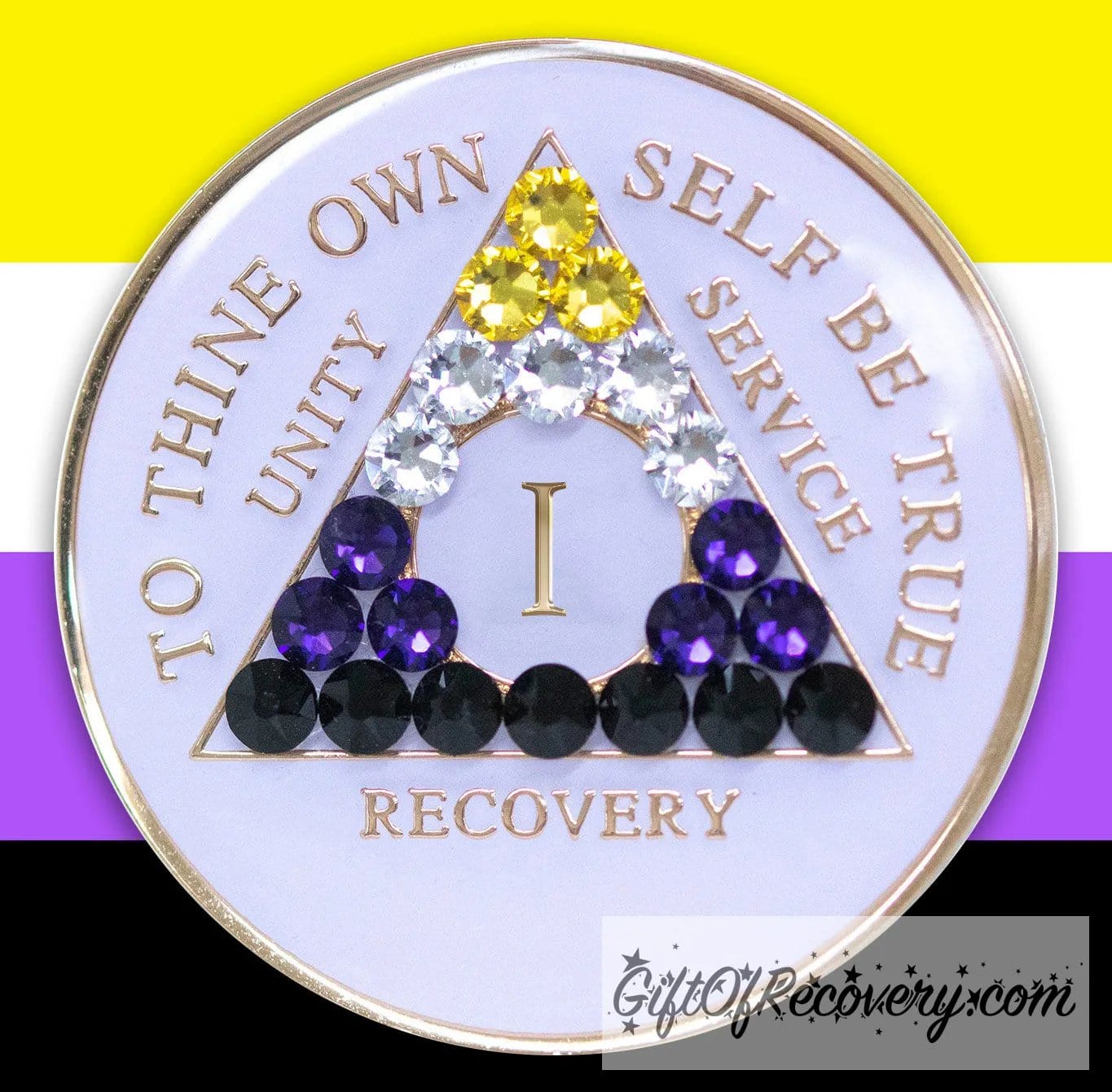 1 year AA medallion pearl white with 21 genuine crystals that form the triangle and are in the color of the Nonbinary flag, to represent pride and sobriety, the AA slogan and three legacies are embossed with 14k gold-plated brass and sealed with resin for a glossy finish that will last and is scratch proof, pictured on an image of the Nonbinary flag colors.