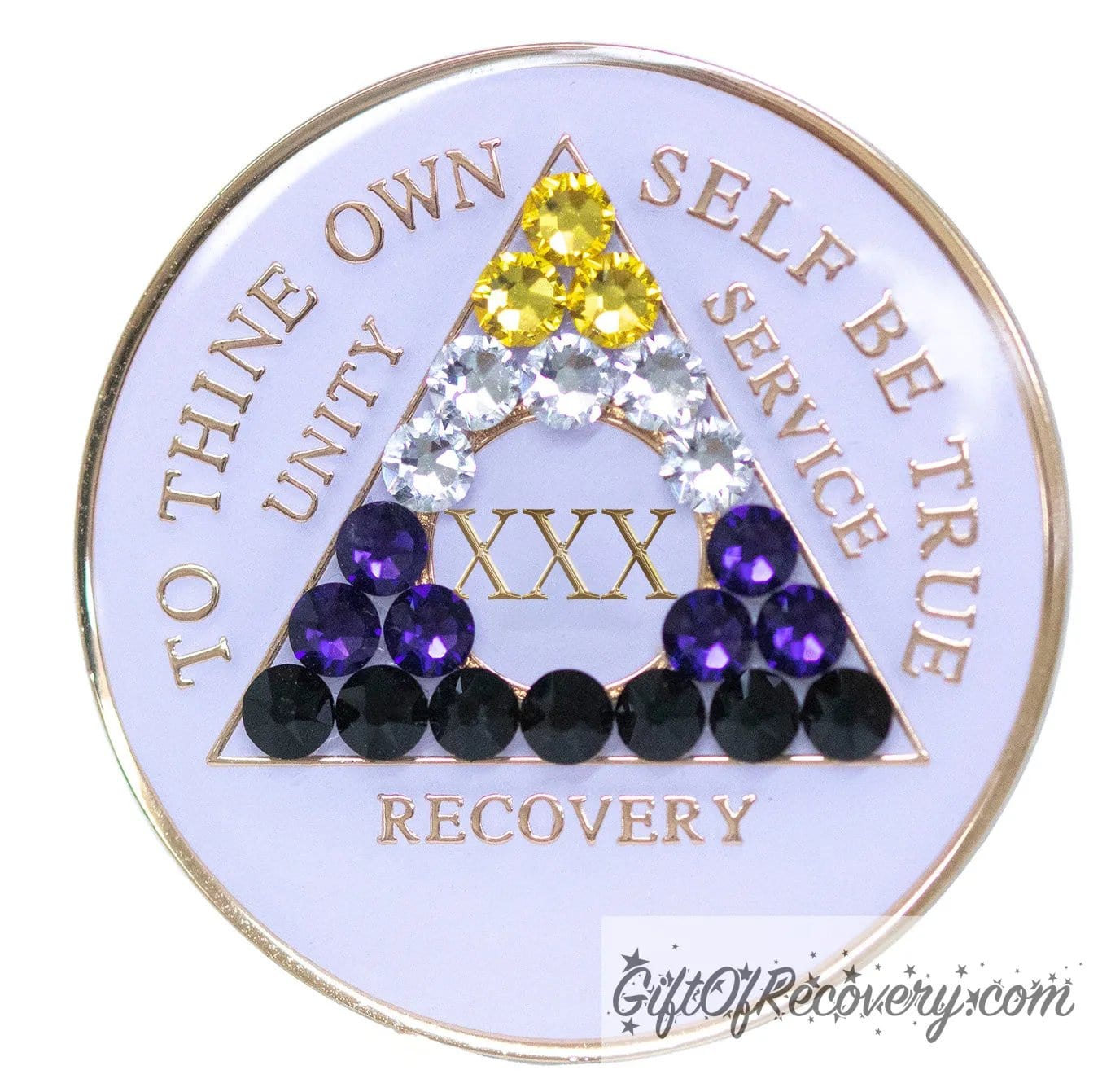 30 year AA medallion pearl white with 21 genuine crystals that form the triangle and are in the color of the nonbinary flag, to represent pride and sobriety, the AA slogan and three legacies are embossed with 14k gold-plated brass and sealed with resin for a glossy finish that will last and is scratch proof.