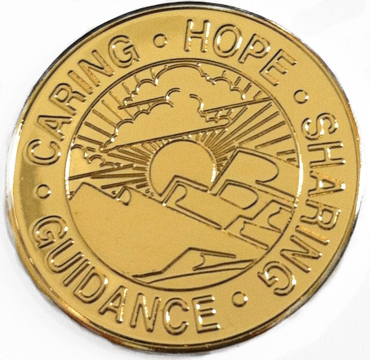 Recovery medallion Sponsorship gold-plated, with a scenic picture in the center and caring, hope, guidance, and sharing going around the outside of the circle.