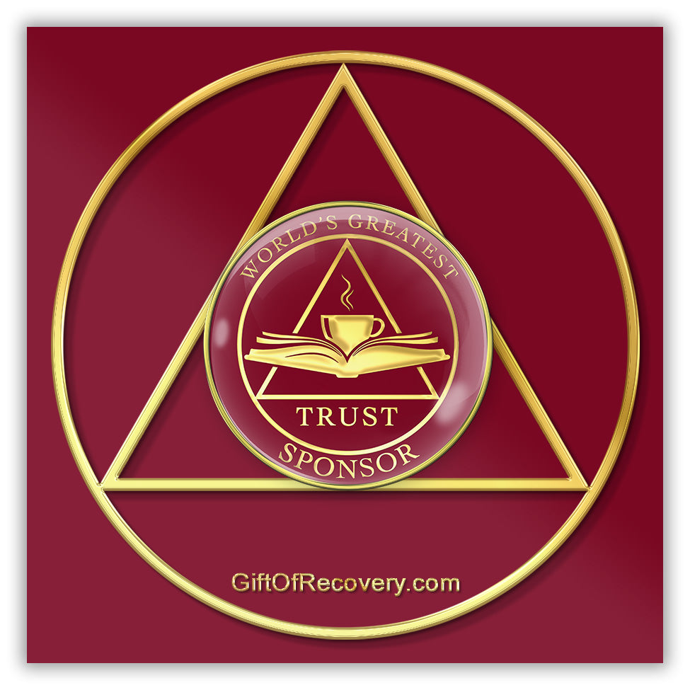 AA medallion Ruby red with a triangle, and open book with a coffee cup overlapping with the word trust at the bottom, worlds greatest at the top of the medallion and sponsor at the bottom, sealed with resin for a glossy finish, featured on a red 3x3 card that is a replica of the recovery medallion.