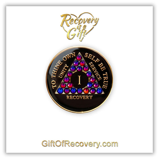 Recovery Medallion 1 Year black onyx with 21 volcano crystals in the shape of the triangle and to thine own self be true, unity, service, recovery along with rim of medallion, are embossed with 14k gold-plated brass and sealed in resin for a high glossy shine that is scratch resistant, the recovery medallion is featured on a white 3x3 card with recovery is a gift and giftofrecovery.com in the color gold.  