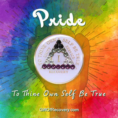 1 year AA medallion pearl white with 21 genuine crystals that make up the Asexual flag to represent recovery and pride, sobriety is a safe space, the AA slogan and three legacies are embossed with 14k gold-plated brass, sealed with resin for a glossy finish, pictured on a 3x3 tie-dye card with a silhouette of a fist and the words pride and to thine own self be true in the color white. 