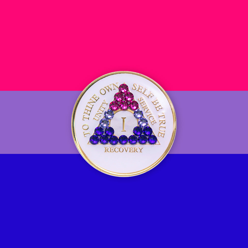 1 year AA medallion pearl white with 21 genuine crystals that form the triangle and are in the color of the bisexual flag, to represent pride and sobriety, the AA slogan and three legacies are embossed with 14k gold-plated brass and sealed with resin for a glossy finish that will last and is scratch proof, pictured on an image of the Bisexual flag colors. 