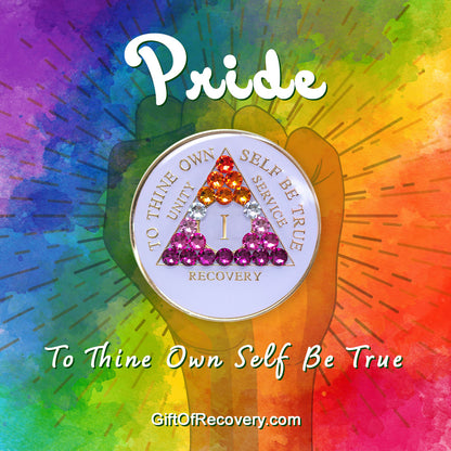 1 year AA medallion pearl white with 21 genuine crystals that form the triangle and are in the color of the Lesbian flag, colors are, to represent pride and sobriety, the AA slogan and three legacies are embossed with 14k gold-plated brass and sealed with resin for a glossy finish that will last and is scratch proof, pictured on  tie-dye 3x3 card with a silhouette of a fist and the words pride and to thine own self be true in bold white. 