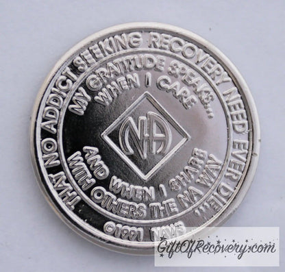 Back of NA nickel plated crystalized light rose medallion has the NAWS official slogans and motto. 