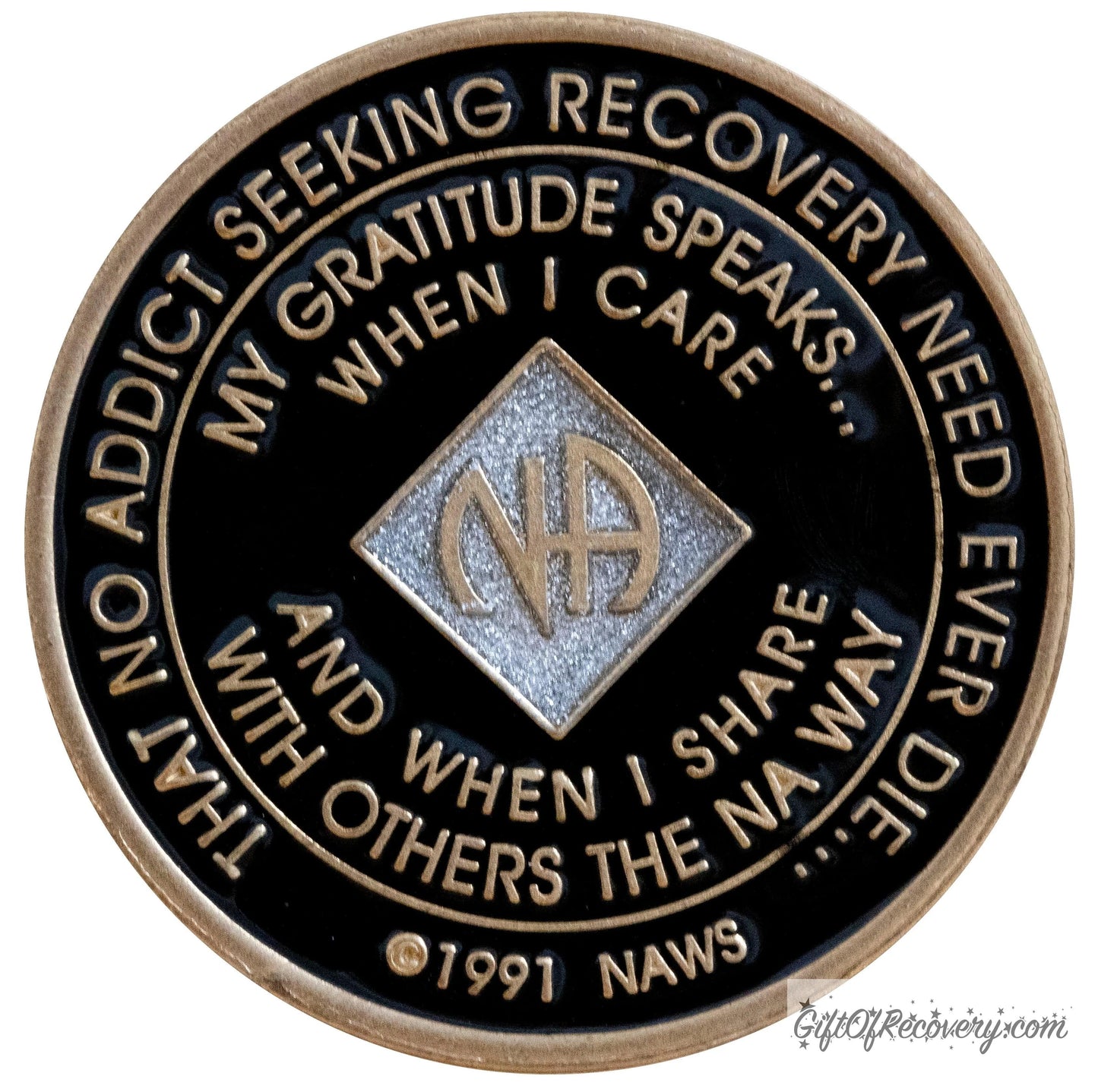 Back of official Narcotics Anonymous medallion has the NAWS official slogans and motto. 