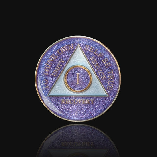 1 year AA medallion Amethyst purple glitter, triangle is pearl white, to thine own self be true, unity, service, recovery, and roman numeral are embossed with 14k gold-plated brass, the recovery medallion is sealed with resin for a glossy finish that will last and is scratch free, featured in a 15 second video with a black background.