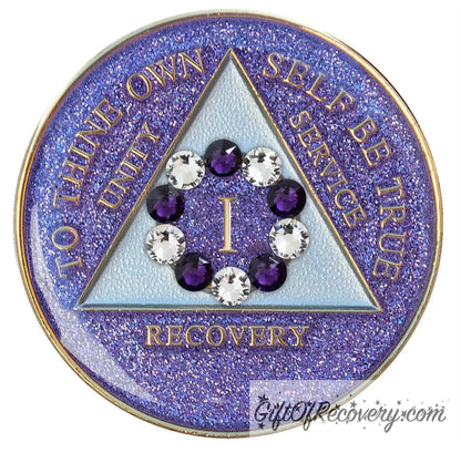 1 year AA medallion Amethyst purple glitter set in a circle around the roman numeral are 6 purple crystal and 6 CZ diamond, ten genuine crystal that represent the 10th step of AA, the triangle is pearl white and the AA moto is embossed with 14k gold-plated brass, sealed with resin for a shiny finish that will last and is scratch proof. 