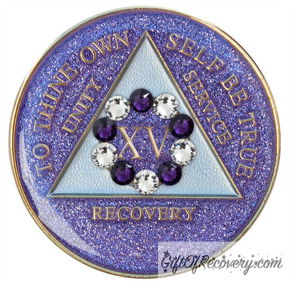 15 year AA medallion Amethyst purple glitter set in a circle around the roman numeral are 6 purple crystal and 6 CZ diamond, ten genuine crystal that represent the 10th step of AA, the triangle is pearl white and the AA moto is embossed with 14k gold-plated brass, sealed with resin for a shiny finish that will last and is scratch proof.