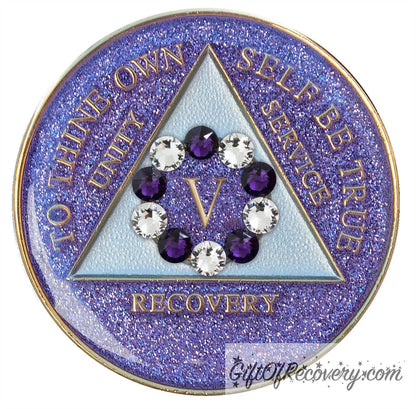 5 year AA medallion Amethyst purple glitter set in a circle around the roman numeral are 6 purple crystal and 6 CZ diamond, ten genuine crystal that represent the 10th step of AA, the triangle is pearl white and the AA moto is embossed with 14k gold-plated brass, sealed with resin for a shiny finish that will last and is scratch proof.