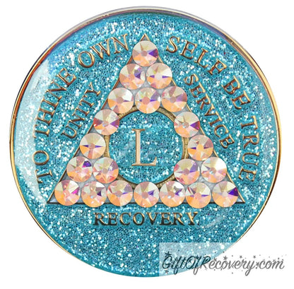 50 year deep sea aqua glitter AA medallion adorned with 21 genuine Aurora Borealis crystals representing the different colors and stages of our new lives, to thine own self be true, unity, service, recovery are embossed with 14k gold-plated brass and sealed with resin for a glossy finish that is scratch proof and will last.