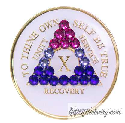 10 year AA medallion pearl white with 21 genuine crystals that form the triangle and are in the color of the bisexual flag, to represent pride and sobriety, the AA slogan and three legacies are embossed with 14k gold-plated brass and sealed with resin for a glossy finish that will last and is scratch proof.