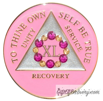 40 year AA medallion princess pink with 6 fuchsia pink genuine crystals and 6 gold to form a circle around the roman numeral to represent bloom, we grow and blossom when we work the program, triangle is pearl white with the AA slogan and three legacies embossed in 14k gold-plated brass, sealed with resin for a glossy finish.