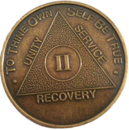 2 year bronze AA medallion, with triangle and AA slogan and motto.