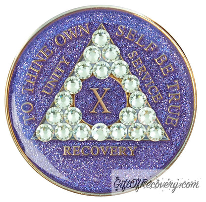 10 year AA medallion purple glitter with 21 genuine diamond CZ crystals in the shape of the triangle, with to thine own self be true, unity, service, recovery, and the roman numeral embossed with 14k gold-plated brass, the recovery medallion is sealed with resin for a shiny finish that will last and is scratch proof.