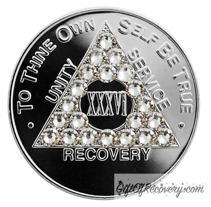 36 year aluminum AA recovery medallion with 21 diamond CZ genuine crystals for the triangle along with the AA slogan and three legacies.