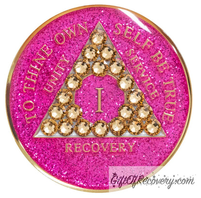 1 year AA recovery medallion in glitter princess pink and adorned with 21 gold CZ genuine crystals shaped in the triangle to add sparkle to your sober princess journey in recovery, to thine own self be true, unity, service, recovery are embossed with 14k gold-plated brass and sealed with resin for a glossy finish that will last and is scratch proof.