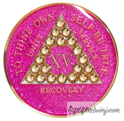 15 year AA recovery medallion in glitter princess pink and adorned with 21 gold CZ genuine crystals shaped in the triangle to add sparkle to your sober princess journey in recovery, to thine own self be true, unity, service, recovery are embossed with 14k gold-plated brass and sealed with resin for a glossy finish that will last and is scratch proof.