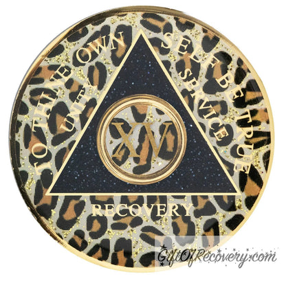 15 year AA medallion leopard print with gold flaked spots, to thine own self be true, unity, service, recovery, and roman numeral are gold foil so you can let your recovery shine, not your time, the circle triangle is embossed with 14k gold-plated brass, the recovery medallion is sealed with resin for a shiny finish.