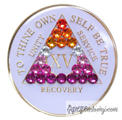 15 year AA medallion pearl white with 21 genuine crystals that form the triangle and are in the color of the Lesbian flag, colors are, to represent pride and sobriety, the AA slogan and three legacies are embossed with 14k gold-plated brass and sealed with resin for a glossy finish that will last and is scratch proof.