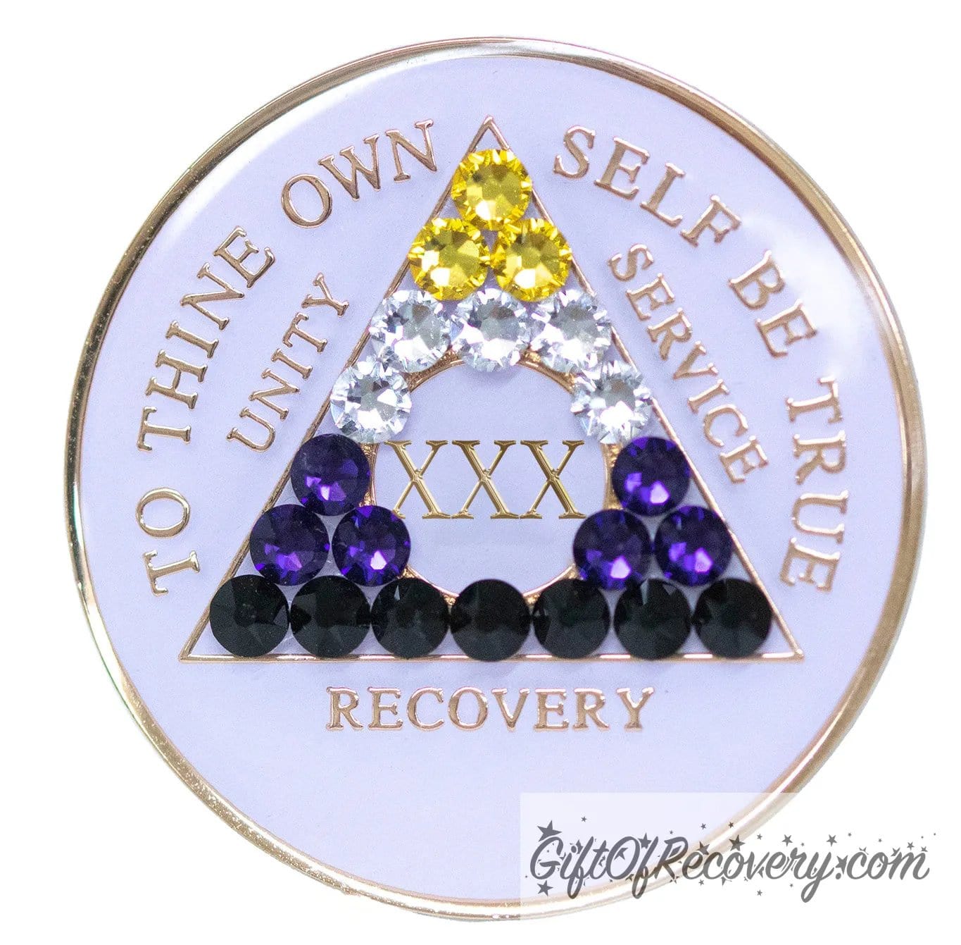 30 year AA medallion pearl white with 21 genuine crystals that form the triangle and are in the color of the nonbinary flag, to represent pride and sobriety, the AA slogan and three legacies are embossed with 14k gold-plated brass and sealed with resin for a glossy finish that will last and is scratch proof.