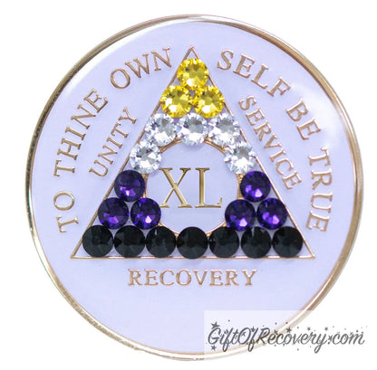 40 year AA medallion pearl white with 21 genuine crystals that form the triangle and are in the color of the nonbinary flag, to represent pride and sobriety, the AA slogan and three legacies are embossed with 14k gold-plated brass and sealed with resin for a glossy finish that will last and is scratch proof.