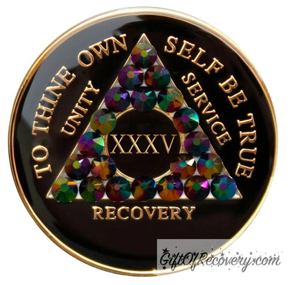 35 year black onyx AA recovery medallion, with 21 genuine peacock crystals, symbolizing the beauty and diversity of recovery journeys, the AA medallion has; to thine own self be true, unity, service, recovery, roman numeral, and the rim, embossed with 14k gold and sealed with resin for a glossy finish.