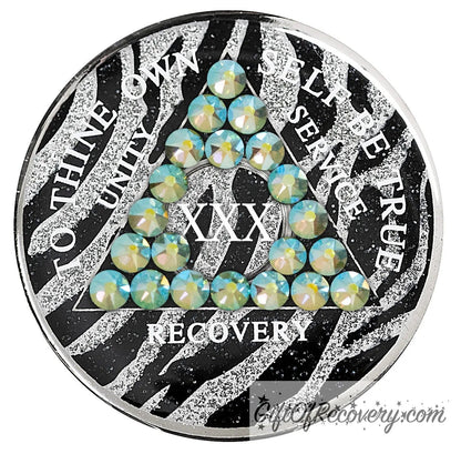 30 year Zebra glitter style AA medallion with 21 genuine peridot crystals, AA moto, unity, service, recovery, and roman numeral are in white and blend into the pattern, so you can let your recovery shine, not your time, the outer rim is silver plated, sealed in a high-quality, chip and scratch-resistant resin dome giving it a beautiful glossy look that will last.