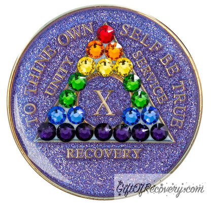 10 year AA medallion Amethyst purple glitter adorned with 21 crystals that represent the rainbow and new beginnings in the recovery journey or the LBGTQIA+ community, show your pride and your time, the AA moto and roman numeral are embossed with 14k gold-plated brass, sealed with resin for a shiny finish that will last and is scratch proof.