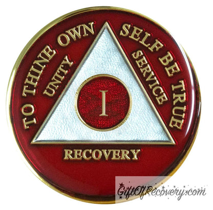 1 year AA medallion Ruby red, this vibrant color is to ignite the fire in your recovery and keep it lit, triangle is pearl white, to thine own self be true, unity, service, recovery, and roman numeral are embossed with 14k gold-plated brass, the recovery medallion is sealed with resin for a glossy finish that will last and is scratch free.