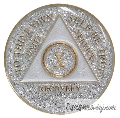 10 year AA medallion Glitter silver, always shine on in sobriety, triangle is pearl white, to thine own self be true, unity, service, recovery, and roman numeral are embossed with 14k gold-plated brass, the recovery medallion is sealed with resin for a glossy finish that will last and is scratch free.