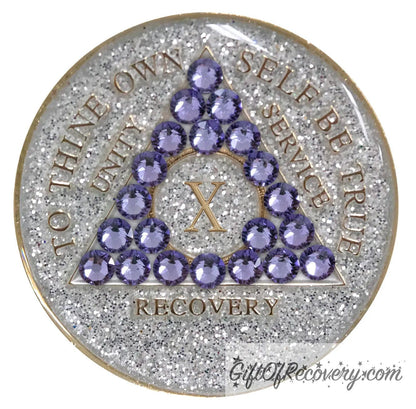 10 year AA medallion silver glitter with 21 purple genuine crystals in the shape of a triangle, to thine own self be true, unity, service, recovery, and roman numeral are embossed with 14k gold-plated brass, sealed in a high-quality, chip and scratch-resistant resin dome giving it a beautiful glossy look that will last.