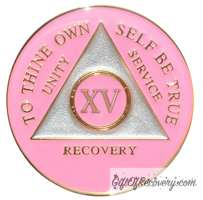 15 year AA medallion Princess pink, the ultimate girl medallion, show off your feminine side, triangle is pearl white, to thine own self be true, unity, service, recovery, and roman numeral are embossed with 14k gold-plated brass, the recovery medallion is sealed with resin for a glossy finish that will last and is scratch free.