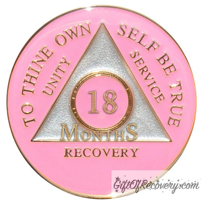 18 months AA medallion Princess pink, the ultimate girl medallion, show off your feminine side, triangle is pearl white, to thine own self be true, unity, service, recovery, and roman numeral are embossed with 14k gold-plated brass, the recovery medallion is sealed with resin for a glossy finish that will last and is scratch free.