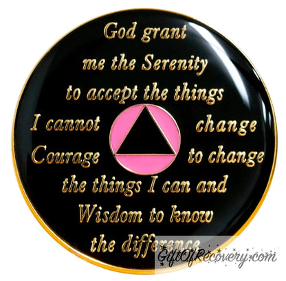 Back of Princess pink AA recovery medallion is black with the circle is pink glitter and triangle black and has the serenity prayer, outer rim, and the circle triangle in the center 14k gold-plated brass, the recovery medallion is sealed with resin for a shiny finish.