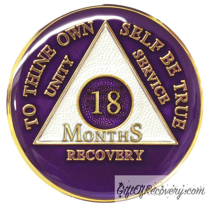 18 Months AA medallion Amethyst purple, recovery is possible, triangle is pearl white, to thine own self be true, unity, service, recovery, and roman numeral are embossed with 14k gold-plated brass, the recovery medallion is sealed with resin for a glossy finish that will last and is scratch free.