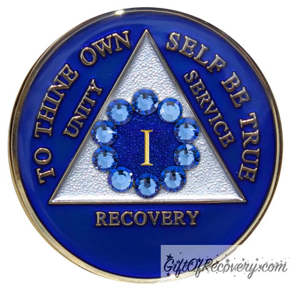 1 year AA medallion Big Book blue, 10 blue genuine crystals in a circle around the roman numeral emphasizing unity in recovery, unity is the legacy that binds us, triangle is pearl white, AA slogan and three legacies are embossed 14k gold-plated brass, recovery medallion is sealed with resin for a glossy finish.