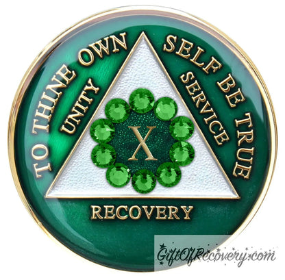 10 year AA medallion Emerald green with 10 green CZ crystals that make a circle around the roman numeral, to symbolize unity, the legacy that binds us, AA slogan and three legacies are embossed with 14k gold-plated brass and sealed for a glossy finish that will last.