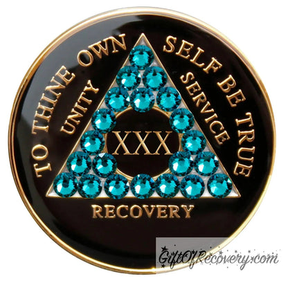 Recovery Medallion 30 Year Black Onyx with twenty-one Blue zircon crystals in the shape of the triangle, with to thine own self be true, roman numeral, and unity, service, recovery embossed with 14k Gold-plated brass and sealed with resin for a glossy shine that is scratch resistant.