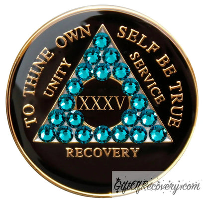 35 Year Recovery Medallion Black Onyx with twenty-one Blue zircon crystals in the shape of the triangle, with to thine own self be true, roman numeral, and unity, service, recovery embossed with 14k Gold-plated brass and sealed with resin for a glossy shine that is scratch resistant.