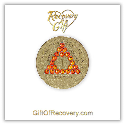 1 year Gold glitter AA medallion with twenty-one fire opal genuine crystals in the shape of a triangle, to thine own self be true, unity, service, recovery embossed in 14k gold-plated brass along with the rim of the medallion, sealed in a high-quality, chip and scratch-resistant resin dome giving it a beautiful glossy look that will last, it is featured on a white 3x3 card with recovery is a gift and giftofrecovery.com.